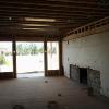 Living room view to new French door location and new portal.